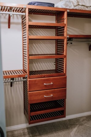 A wooden storage unit with multiple shelves and drawers, likely used for organizing personal items.