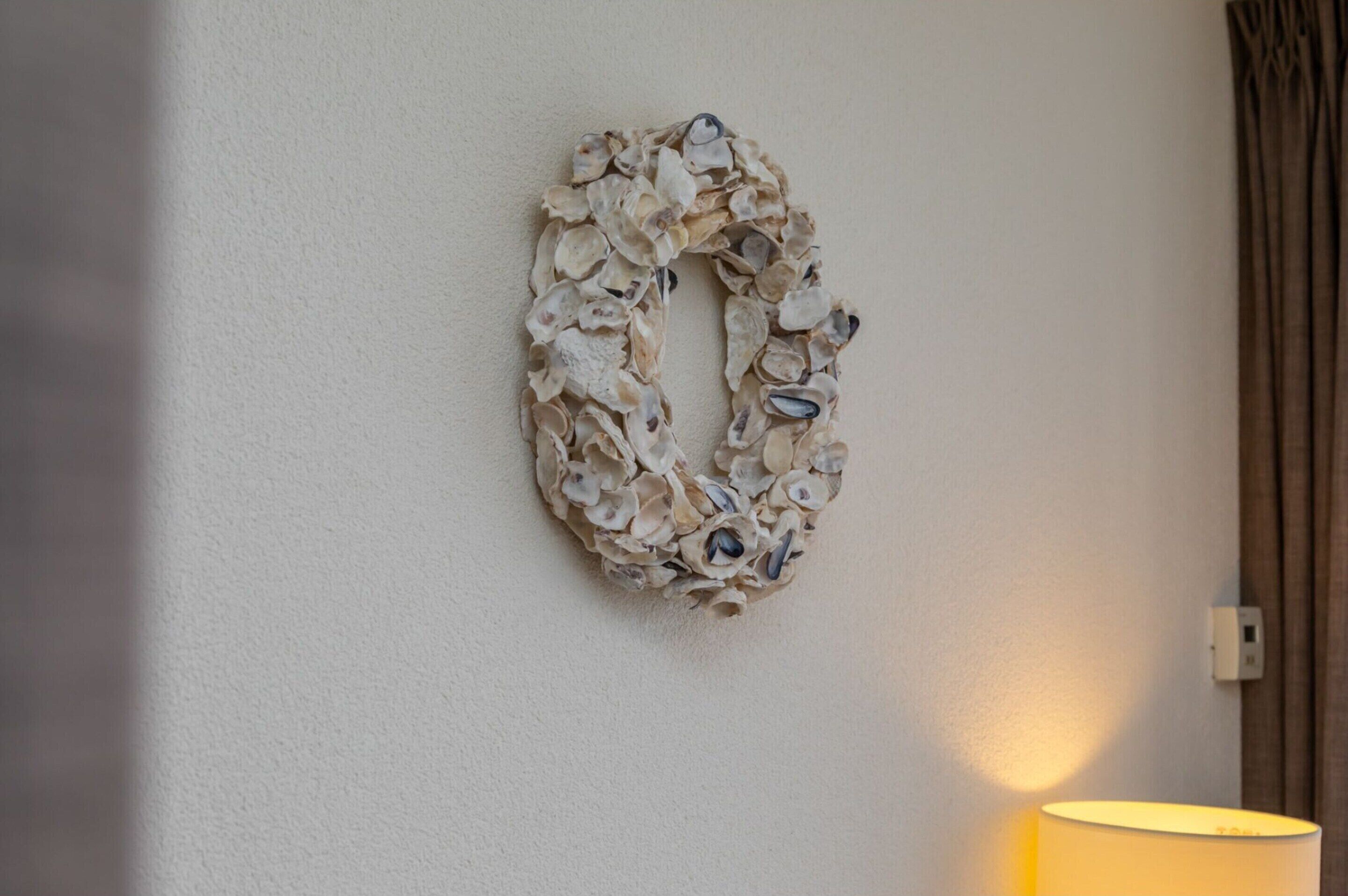 A wall with a decorative arrangement of shells.