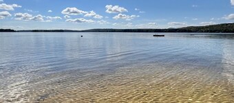SLEEPS 15 WITH A PRIVATE SANDY BEACH ON LONG LAKE.