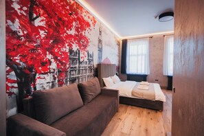A modern bedroom with a large bed, a brown sofa, and a mural of a cityscape. - City Boutique Hotel Reghin (Reghin)