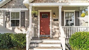 A house with a red door, a mailbox, and a number 917 sign.