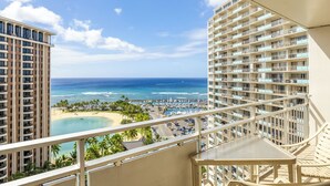 A high-rise hotel with balconies overlooking a beach and marina. - Sweeping Ocean Views | Ilikai Hotel Waikiki 1534 – Heated Pool & Spa (Honolulu)