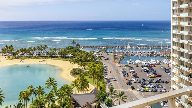 A coastal view with a beach, marina, and high-rise buildings. - Sweeping Ocean Views | Ilikai Hotel Waikiki 1534 – Heated Pool & Spa (Honolulu)