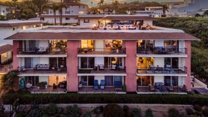 A multi-story hotel with balconies, outdoor seating, and a view of the surrounding area. - SeaCliff - Harbor View - Oceanfront Luxury in Santa Barbara (Santa Barbara)