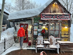 A rustic building with a sign reading 'Camp 4 Coffee' and various signs and decorations on the walls. - Mountain Views, 3BR, HotTub & Ski Access (Crested Butte)