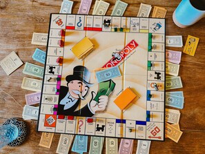 A Monopoly board game with various property names and money denominations.