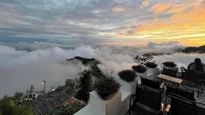 A panoramic view of a mountainous landscape with cloud cover and a sunset. - Ngan Ha Hotel Panorama View (Tam Dao)