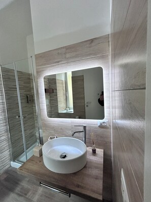 Kamer | Badkamer | Een douche, een haardroger, handdoeken, zeep