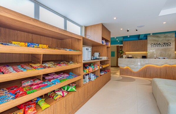 A snack bar with various packaged snacks and a coffee machine.