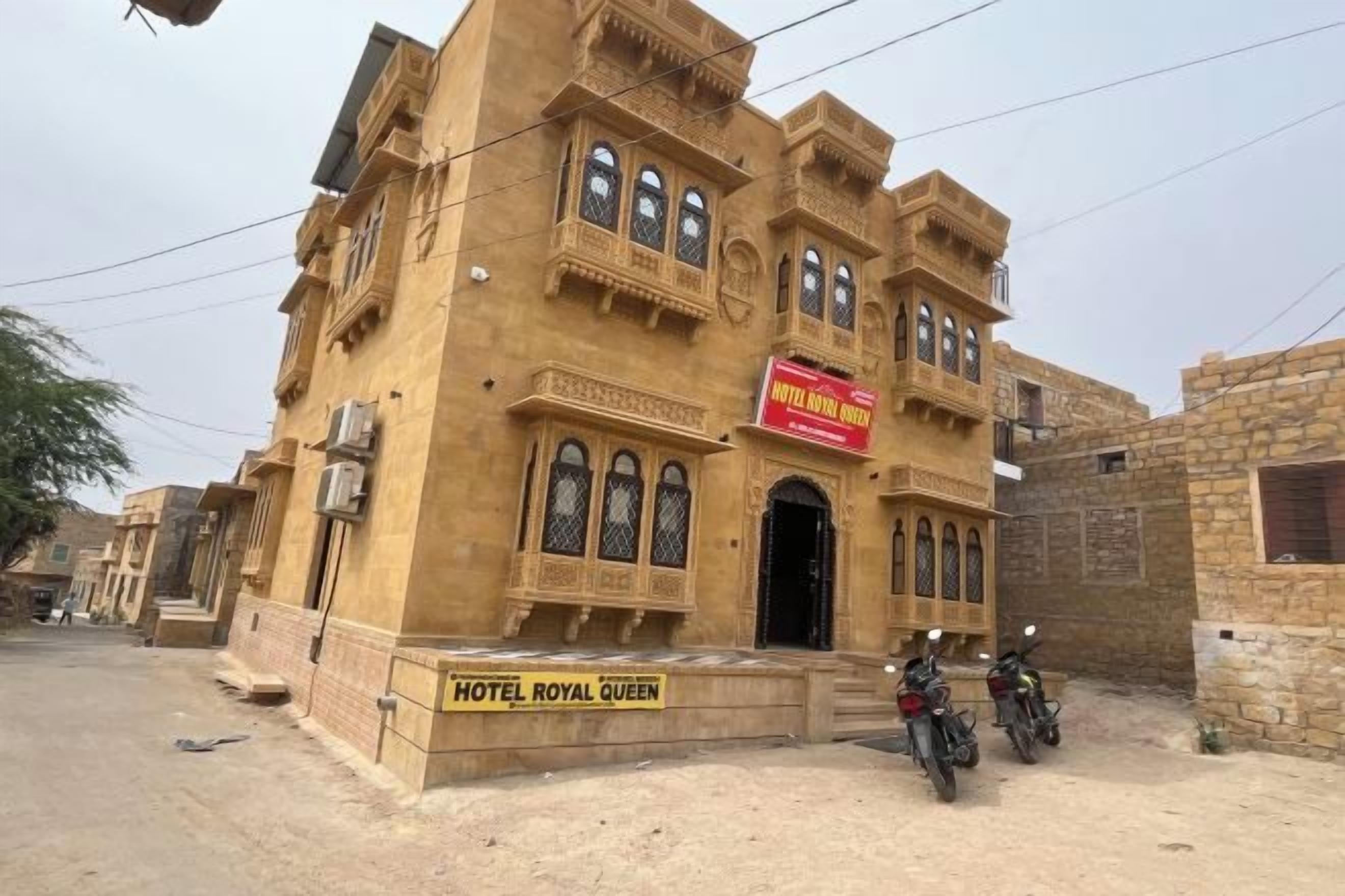 A building with a sign reading 'HOTEL ROYAL QUEEN.'