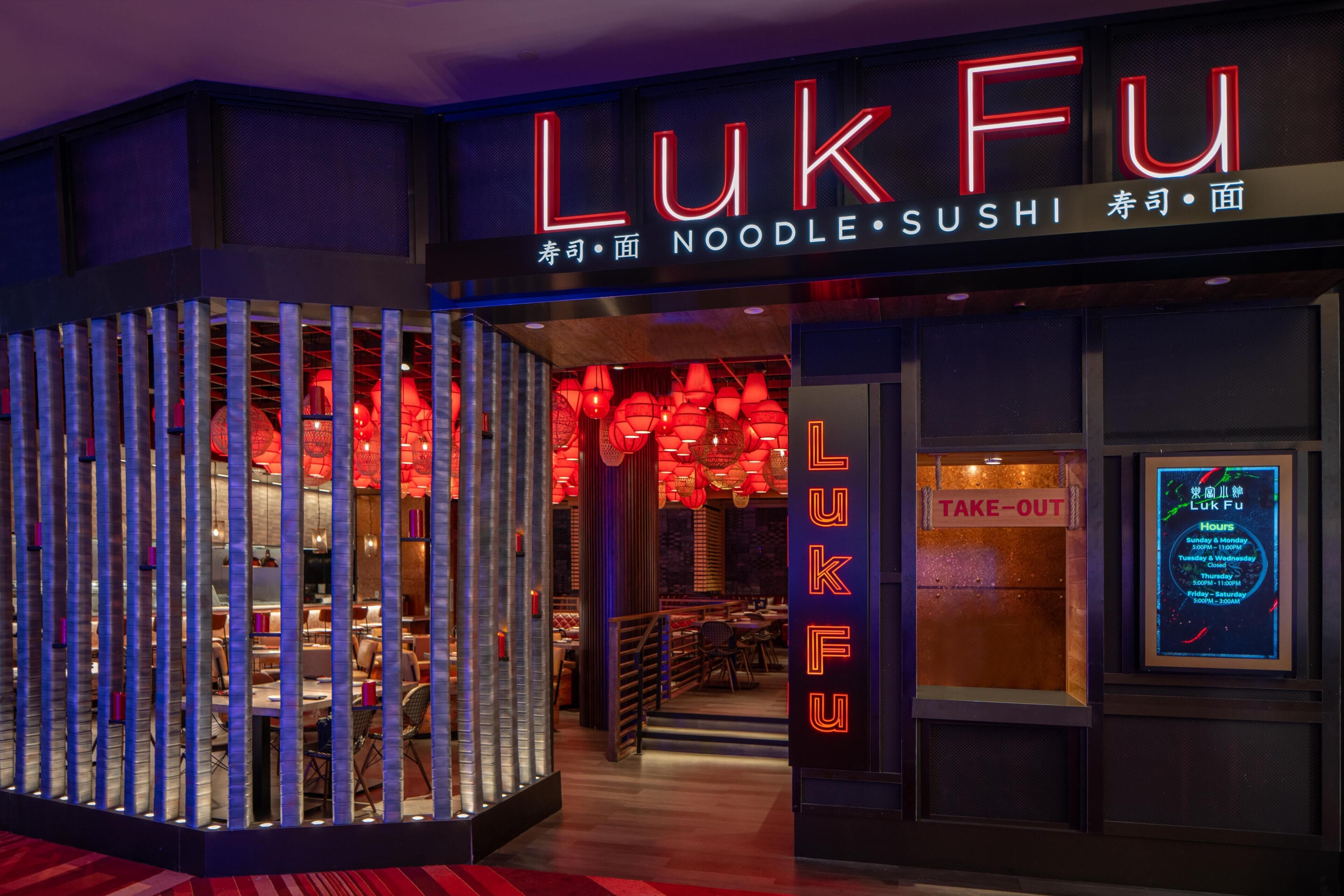 A restaurant named LukFu with a neon sign, a take-out window, and a menu board.