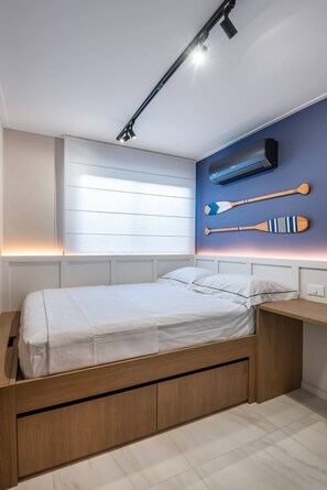 A modern bedroom with a wooden bed, built-in storage, a wall-mounted air conditioner, and a ceiling light fixture. - On the sand with private heated pool (Ipojuca)