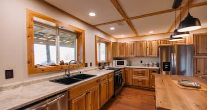 Beautiful Cabin Nestled in a Peaceful Wooded Setting with a Scenic Pond.