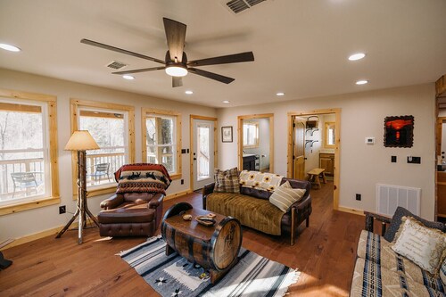 Beautiful Cabin Nestled in a Peaceful Wooded Setting with a Scenic Pond.