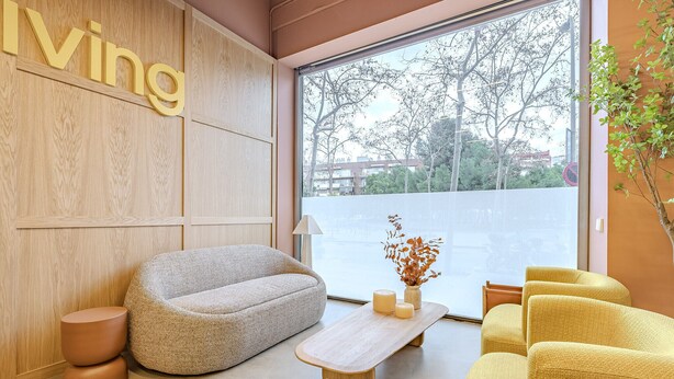 A modern living room with a sofa, a coffee table, and a yellow armchair.