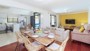A modern living space with a dining area, kitchen, and a sofa set. - Villa Lanzabur - Three Bedroom Villa, Sleeps 6 (Teguise)