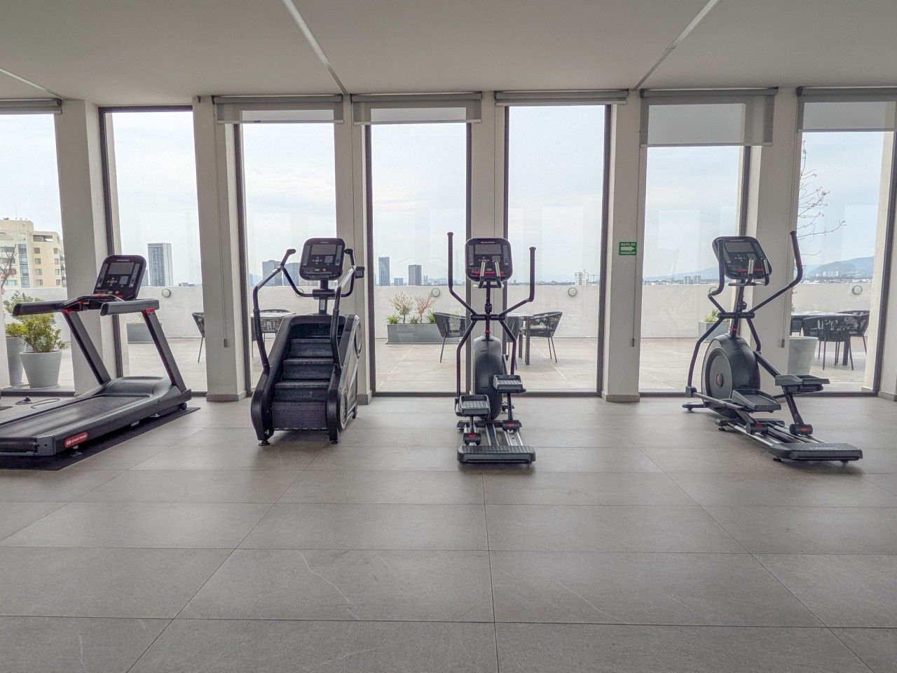 A gym with treadmills, an elliptical, and a stair climber.