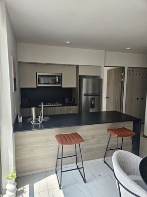 Fridge, microwave, stovetop, coffee/tea maker