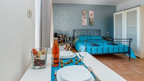 A bedroom with a bed, a bedside table, and a nightstand. - Beachfront Escape in Rovinj - Sea Studio (Rovinj)