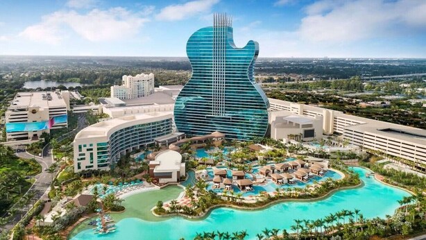 A resort with a large guitar-shaped building, multiple swimming pools, and lush landscaping. - Great Location Heated Pool near Hollywood Beach (Hollywood)