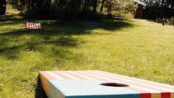 A picnic table in a grassy area with trees in the background.