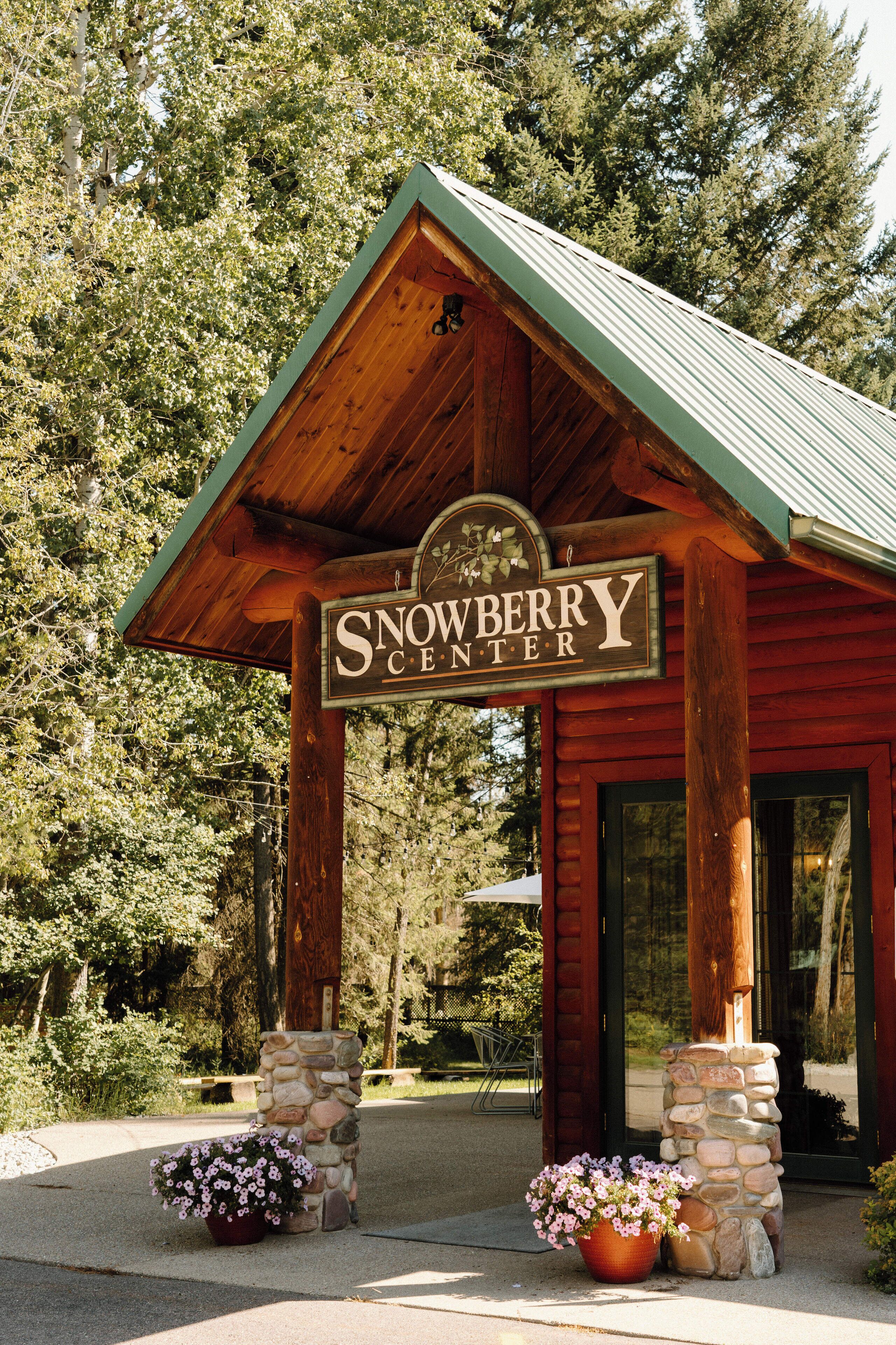 A wooden building with a sign reading "Snowberry Center."