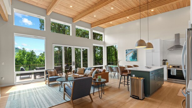 A spacious living area with a large window, a kitchen, and a dining area. - Mtn View, 3 Miles to DT AVL, King Bed, Fire Pit (Asheville)