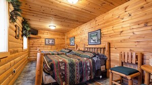 A log cabin room with two wooden beds, a wooden chair, and a small table. - The Frat House at the Riviera Resort in Neillsville, Wisconsin! (Neillsville)