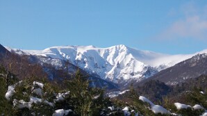 A snow-covered mountain with a clear sky.