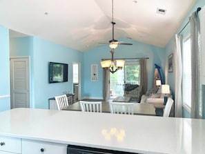 Relax in this inviting space with a large island, dining table, and comfortable sofa.