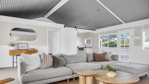 A modern living room with a grey sectional sofa, two round wooden coffee tables, and a large mirror on the wall. - Settle Inn: Broadwater, Pet Friendly (Broadwater)