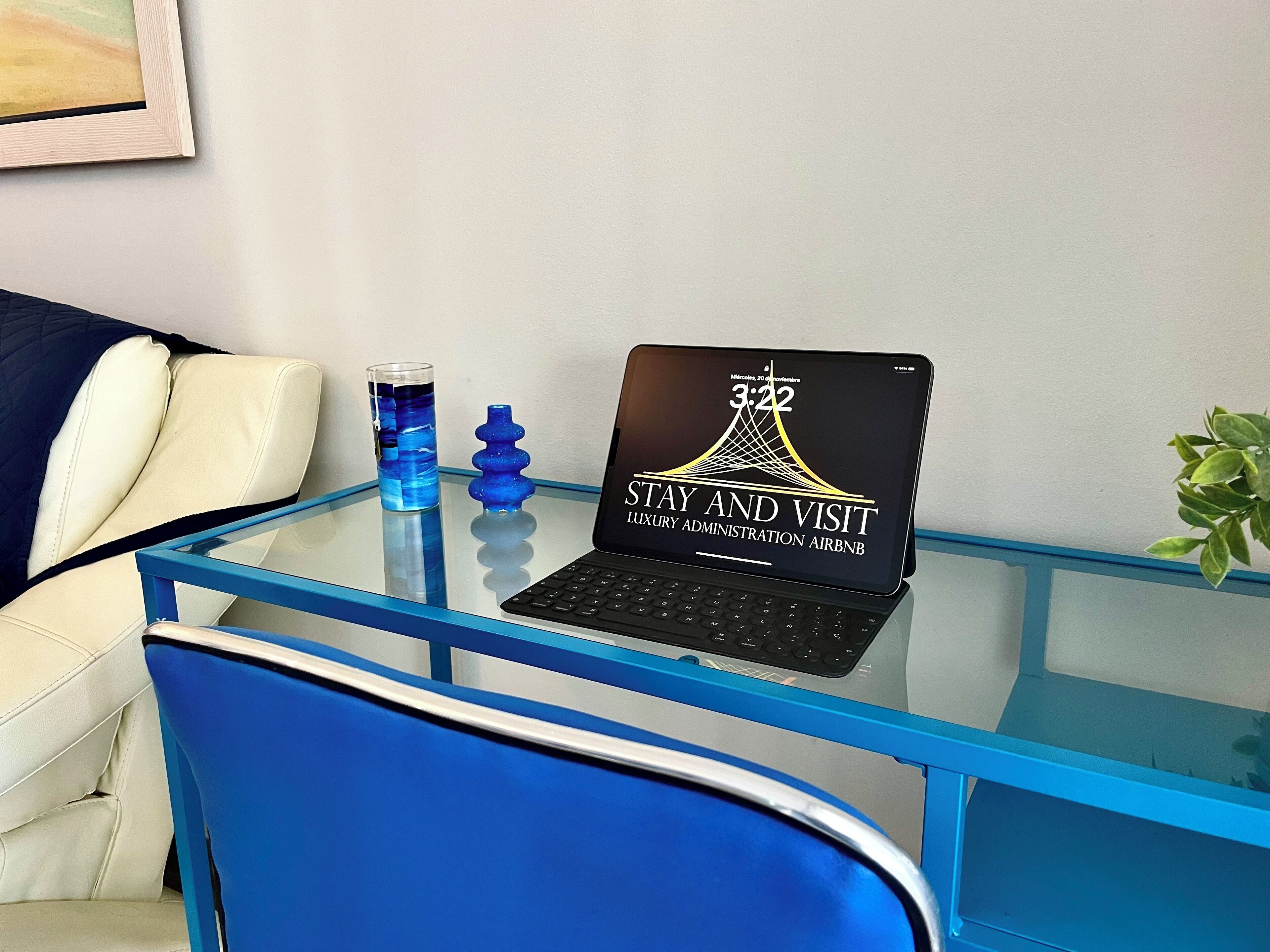 A laptop on a glass table displaying a message for a luxury administration Airbnb.