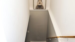 A staircase with a framed picture of a rabbit on the wall. - Le Lodge - Spacious Home (Cochrane)