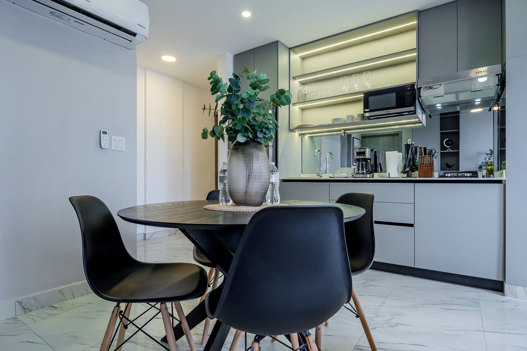 A modern kitchen with a dining area.