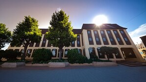 A modern building with a symmetrical facade, large windows, and a central entrance.