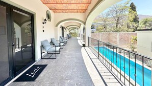 A covered outdoor seating area with a pool, featuring a brick ceiling and a view of the surrounding landscape. - Studio With Salt Water Pool (Chapala)