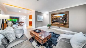 Ein modernes Wohnzimmer mit einer Couch, einem Couchtisch und Kunstwerken an der Wand.