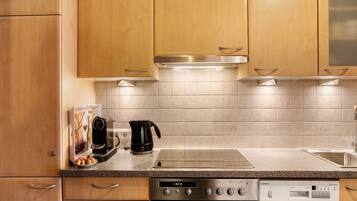 A kitchen with wooden cabinets, a stainless steel range, a dishwasher, and a coffee maker.