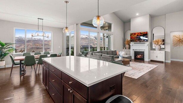 A spacious kitchen with a large island, dining area, and a fireplace. - Luxury Escape in East Wenatchee (East Wenatchee)