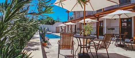 Outdoor pool, open 10:00 AM to 8:00 PM, pool umbrellas, pool loungers