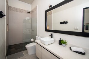 Een douche, handdoeken, zeep, shampoo