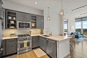 Immerse in a culinary experience in this beautifully designed, fully equipped kitchen. - Tysons Penthouse 2BR | Pool & Gym (McLean)