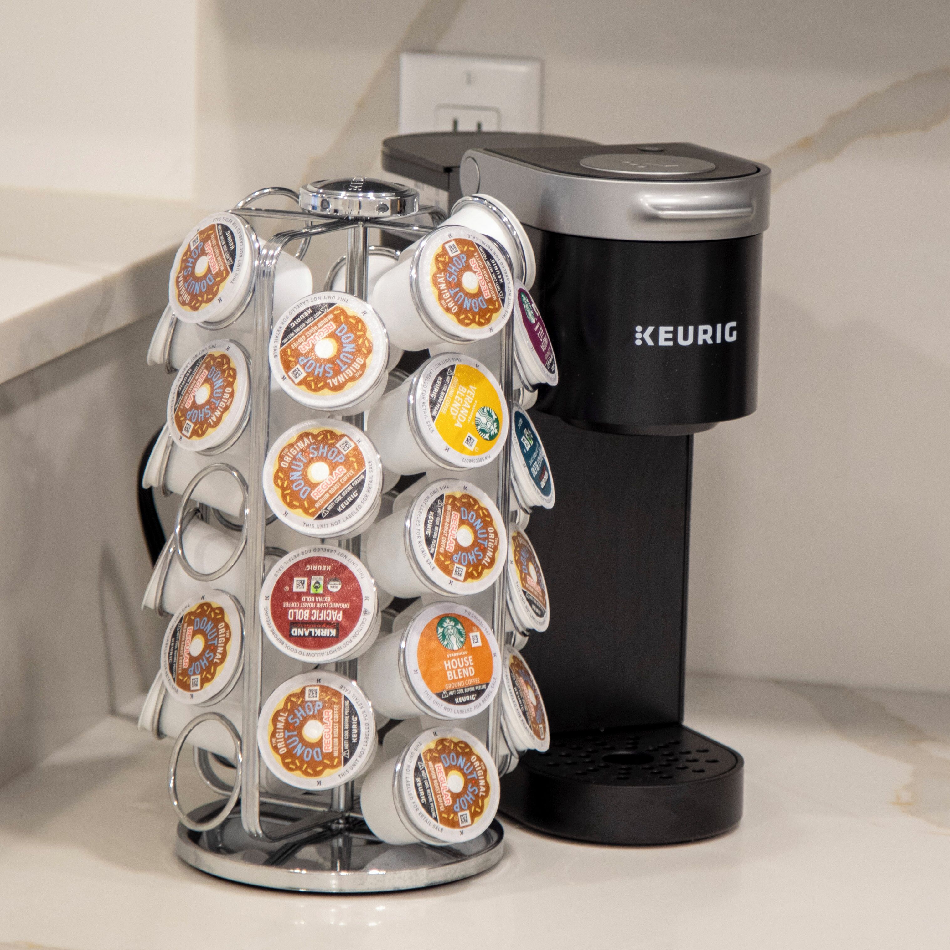 A coffee maker with a drip tray holding multiple coffee pods.