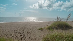 A sandy beach with visible footprints and sparse vegetation. - BT 3824 Pond View Condo - Welcome to Paradise (Fort Pierce)