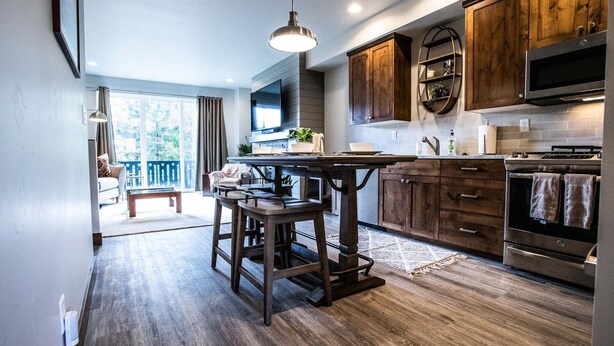 A modern kitchen with wooden cabinets, a central island, and a built-in oven. - Luxury in Downtown McCall, Walking Distance to Everything Downtown (McCall)