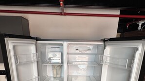 An open refrigerator with multiple shelves and a water dispenser. - Duplex loft base  (Medellín)