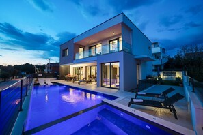 A modern two-story house with a swimming pool, outdoor seating, and a balcony. - Villa Barbara with heated pool (Pakoštane)