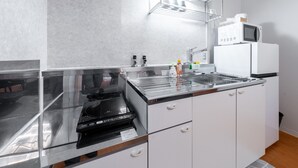 Una cucina moderna con elettrodomestici in acciaio inossidabile, un forno a microonde e un forno integrato.