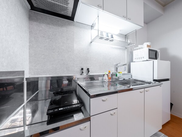 A modern kitchen with stainless steel appliances, a microwave, and a built-in oven. -  Mobius Yasaka Namba Family Suite (Osaka)