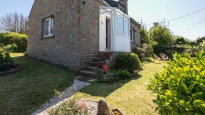 A stone house with a wooden porch and a small garden. - La Grande Roche by Interhome (Porspoder)